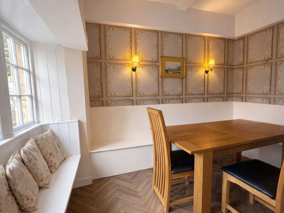 A dining room with a wooden table and chairs at Hanlith Hall near Malham