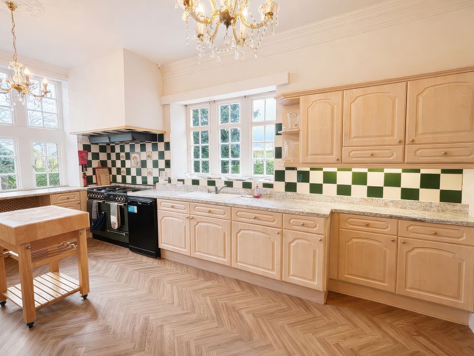 A kitchen with cabinets, a stove, and a countertop at Hanlith Hall in Hanlith near Malham