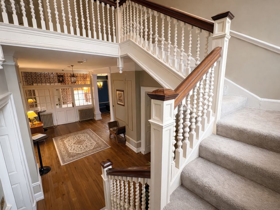 A staircase leading to a second floor in the hallway at Hanlith Hall near Malham