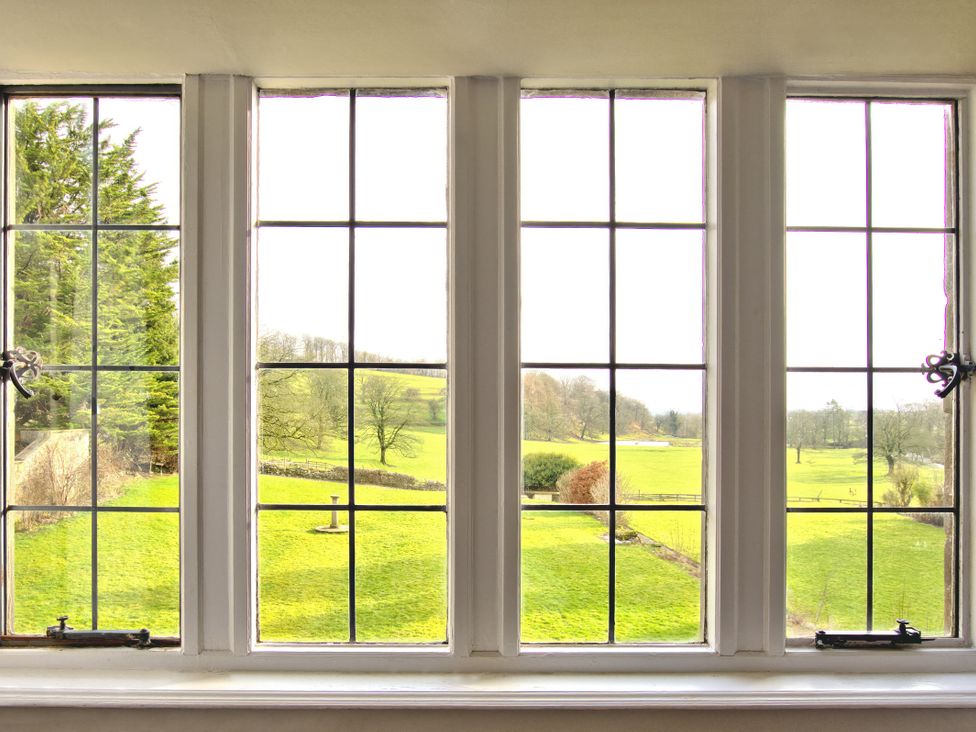 A view through a window showing grass and trees at Hanlith Hall near Malham