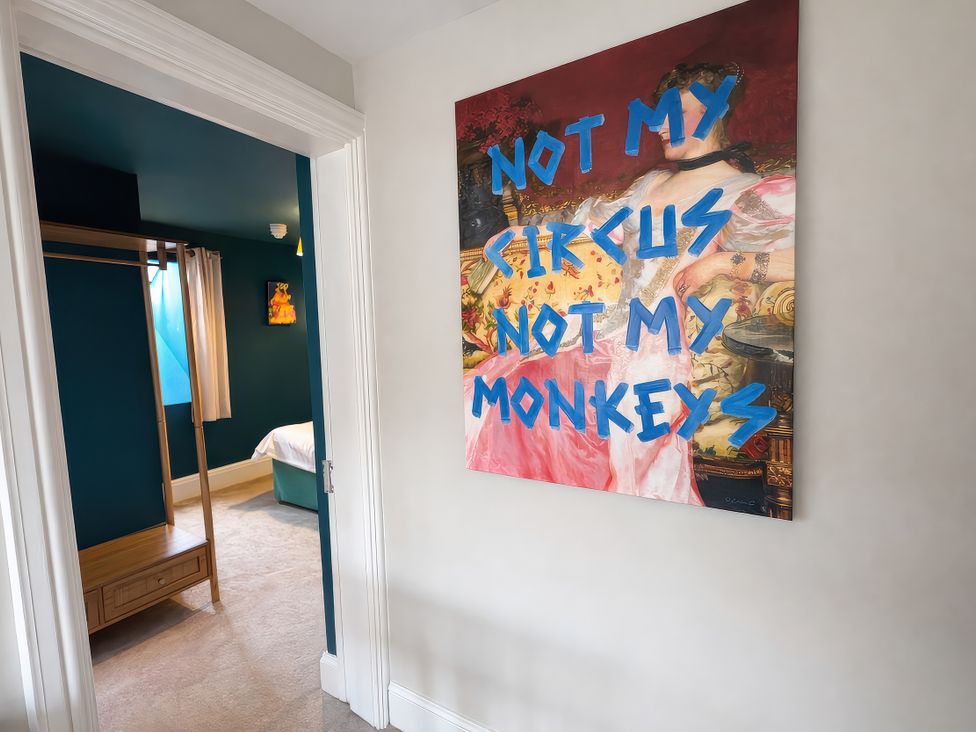 A bedroom with wall art and a closet at Hanlith Hall near Malham