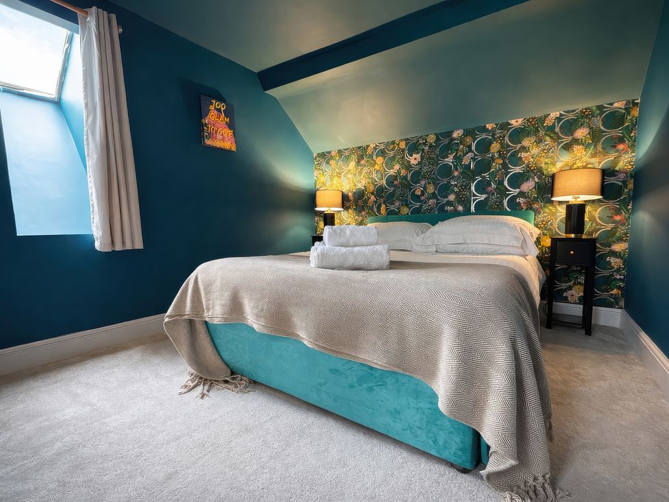 A bedroom with a bed and bedside tables at Hanlith Hall in Hanlith near Malham