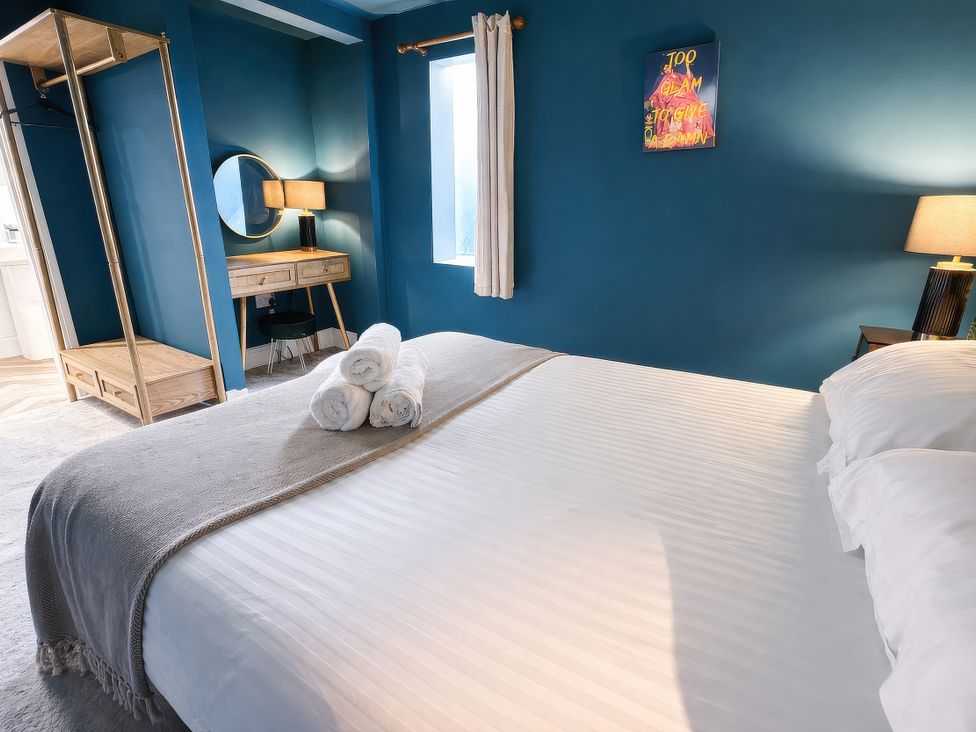 A bedroom with a bed and wardrobe at Hanlith Hall near Malham