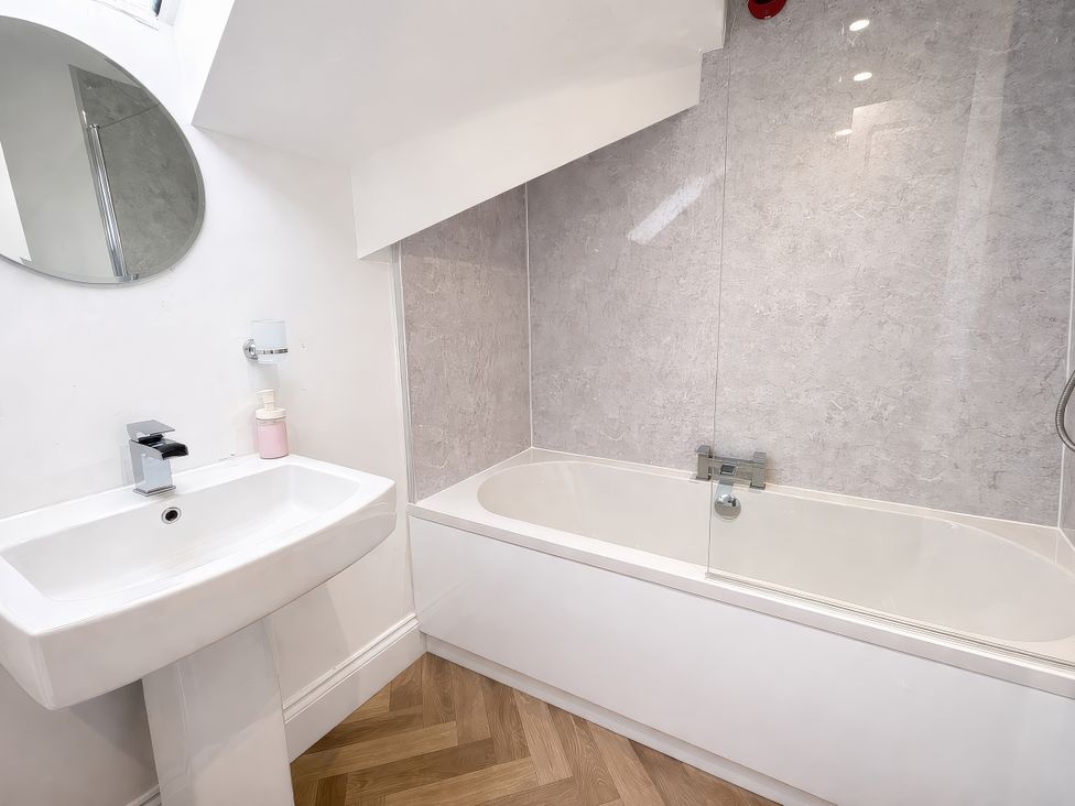 A bathroom with a bathtub and sink at Hanlith Hall Hanlith near Malham