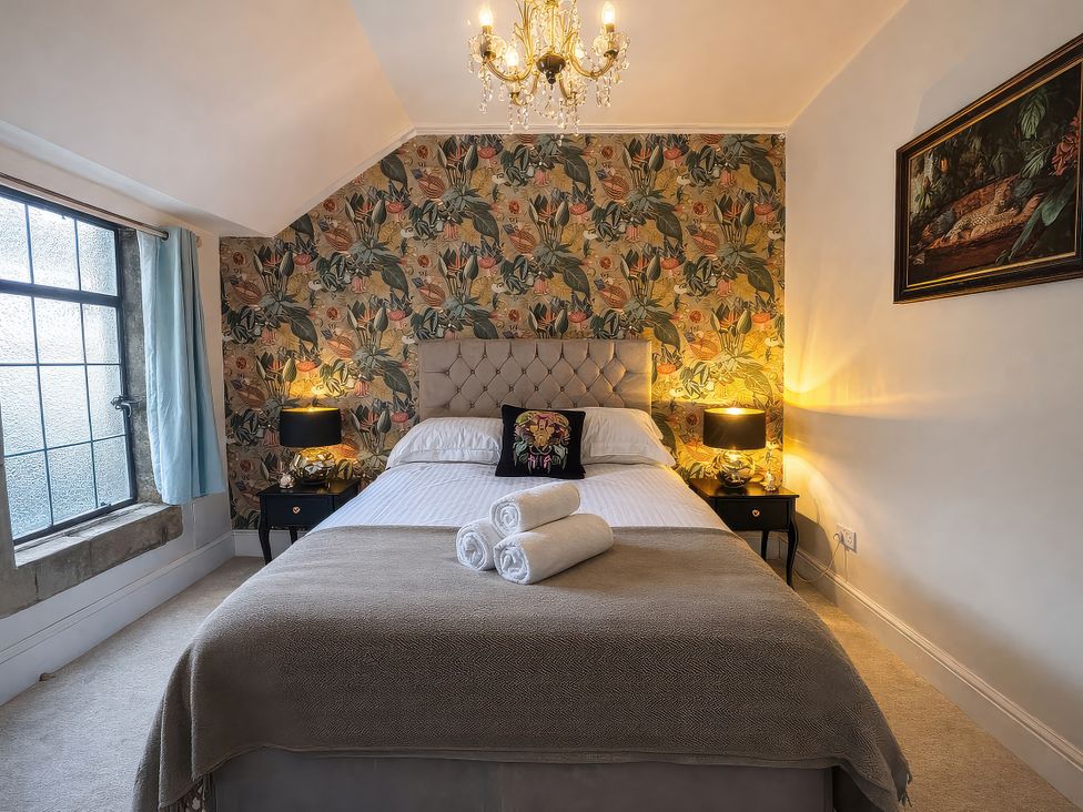 A bedroom with a bed and lamps at Hanlith Hall in Hanlith near Malham