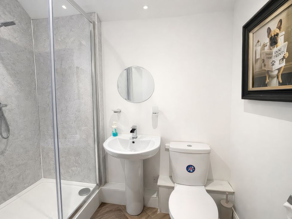 A bathroom with a shower, sink and toilet at Hanlith Hall near Malham