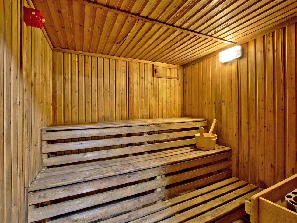 A sauna with wooden benches and a bucket at Hanlith Hall in Hanlith near Malham