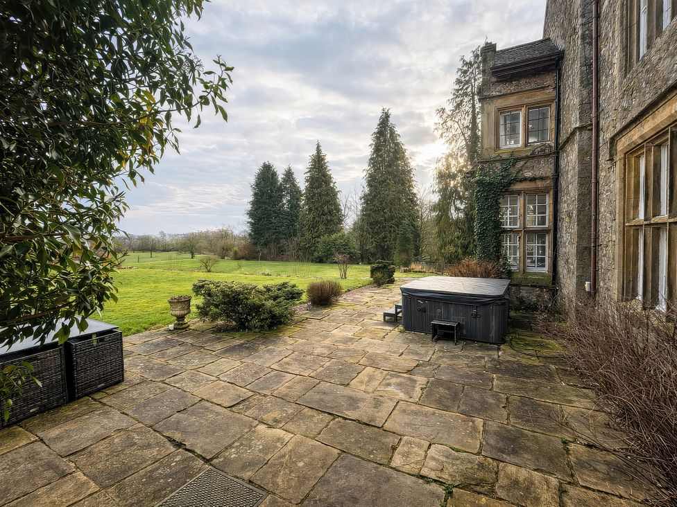 An outdoor area with a hot tub and patio at Hanlith Hall in Hanlith near Malham