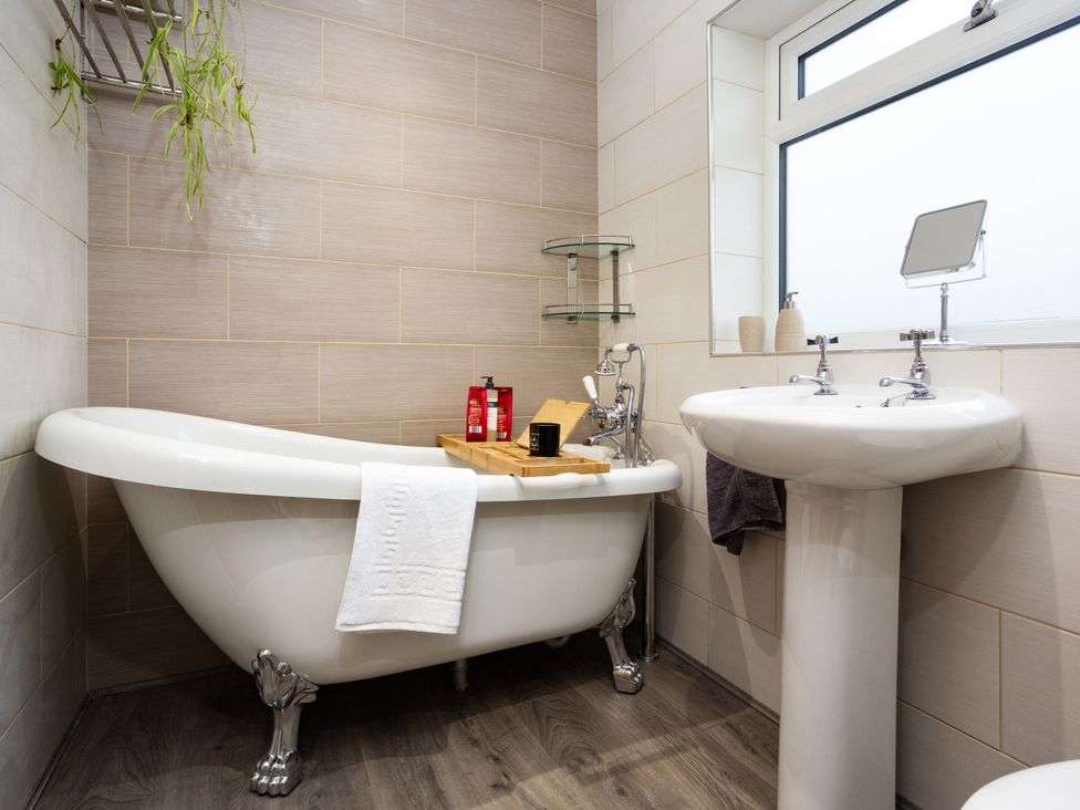 A bathroom featuring a bathtub and wash basin at Thieveley Pike View in Burnley