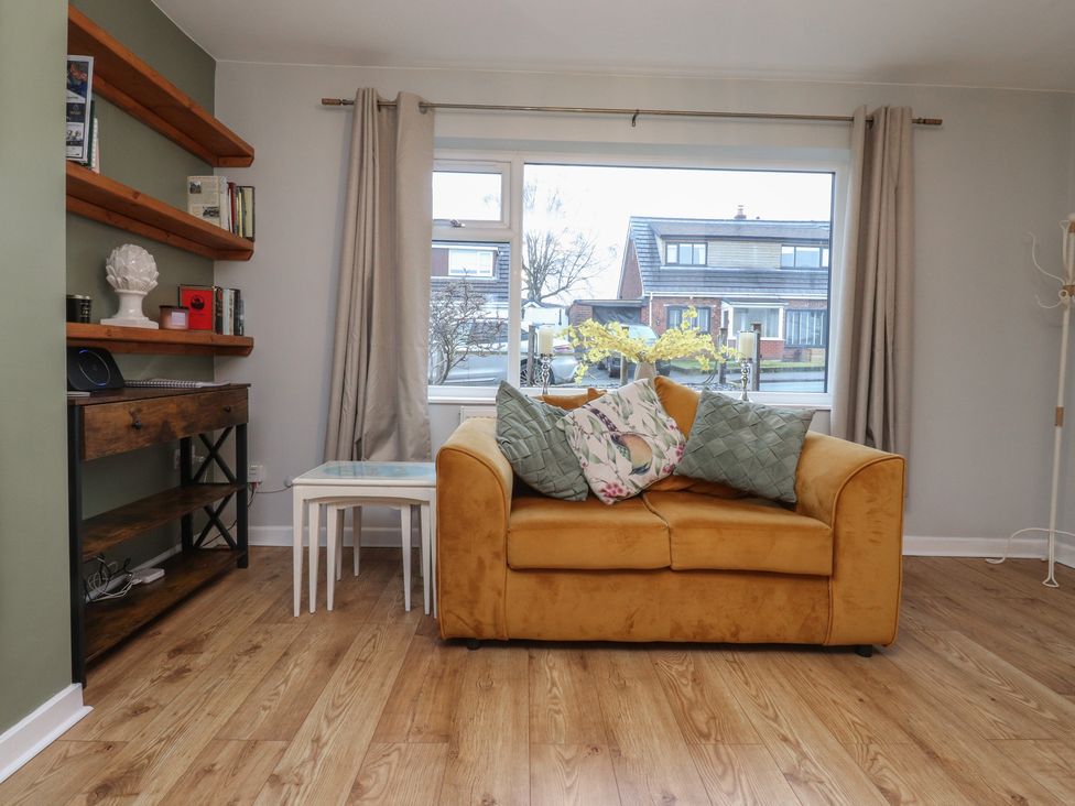 A living room with a sofa and window at Thieveley Pike View in Burnley