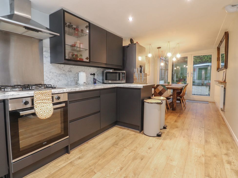 A kitchen with appliances and dining area at Thieveley Pike View in Burnley