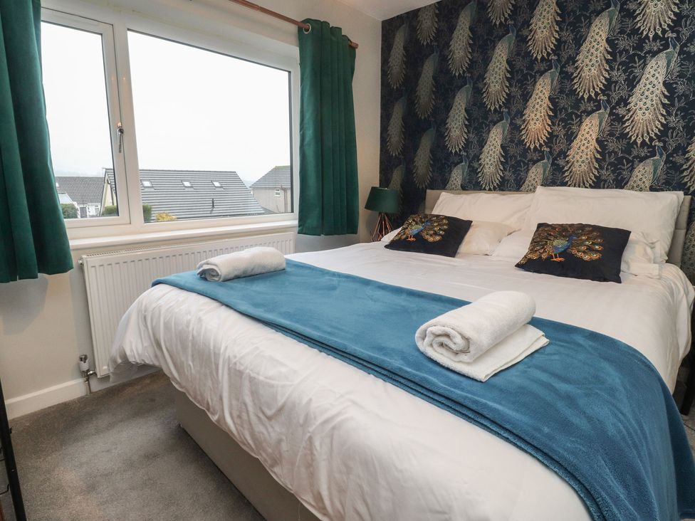 A bedroom with a double bed and window at Thieveley Pike View in Burnley