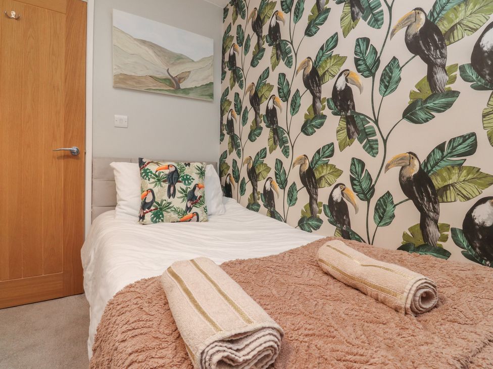 A bedroom with a bed and wall art at Thieveley Pike View in Burnley