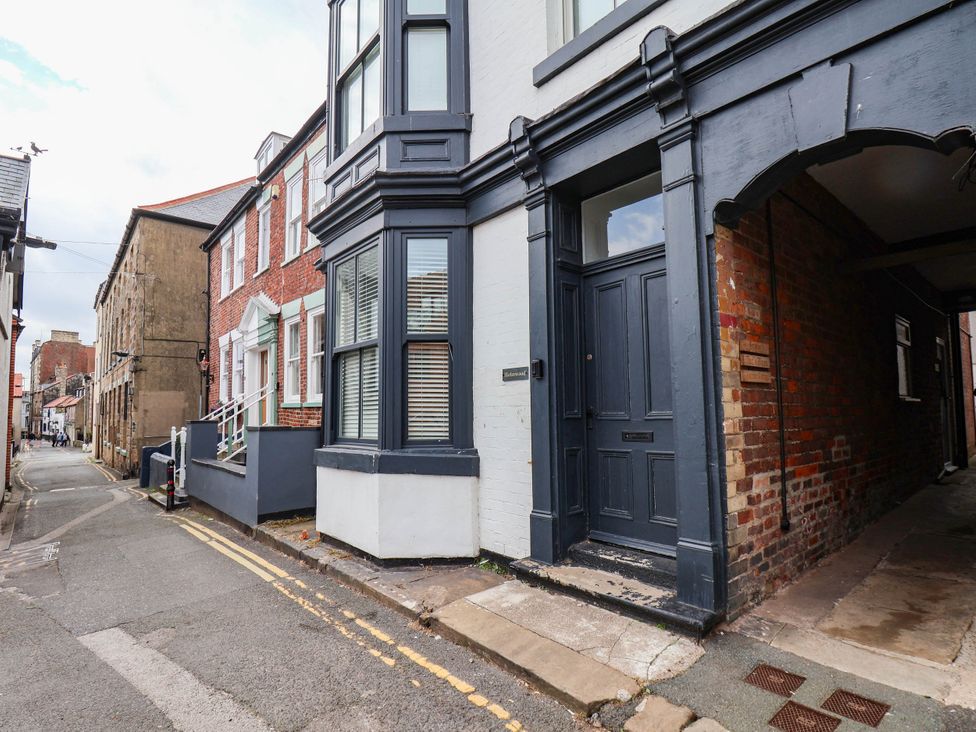 An outdoor view of a building with a door and windows at Holmwood
