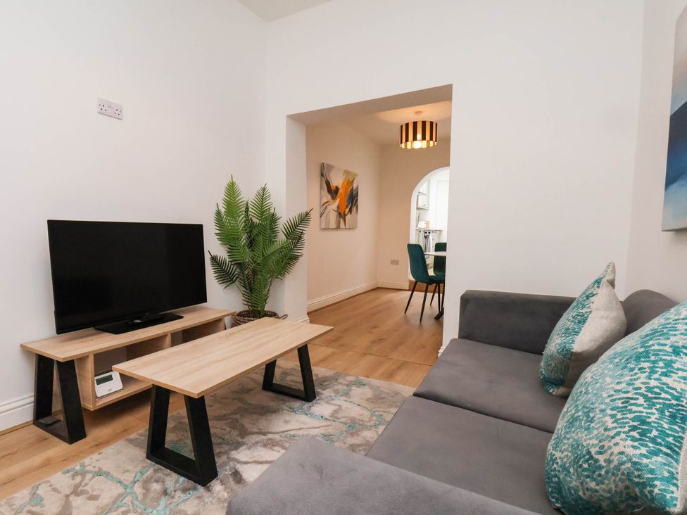 A living room with a television and coffee table at Holmwood