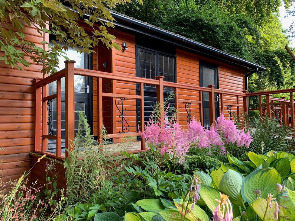 A cabin with steps and railing surrounded by plants at The Hermitage Penrith