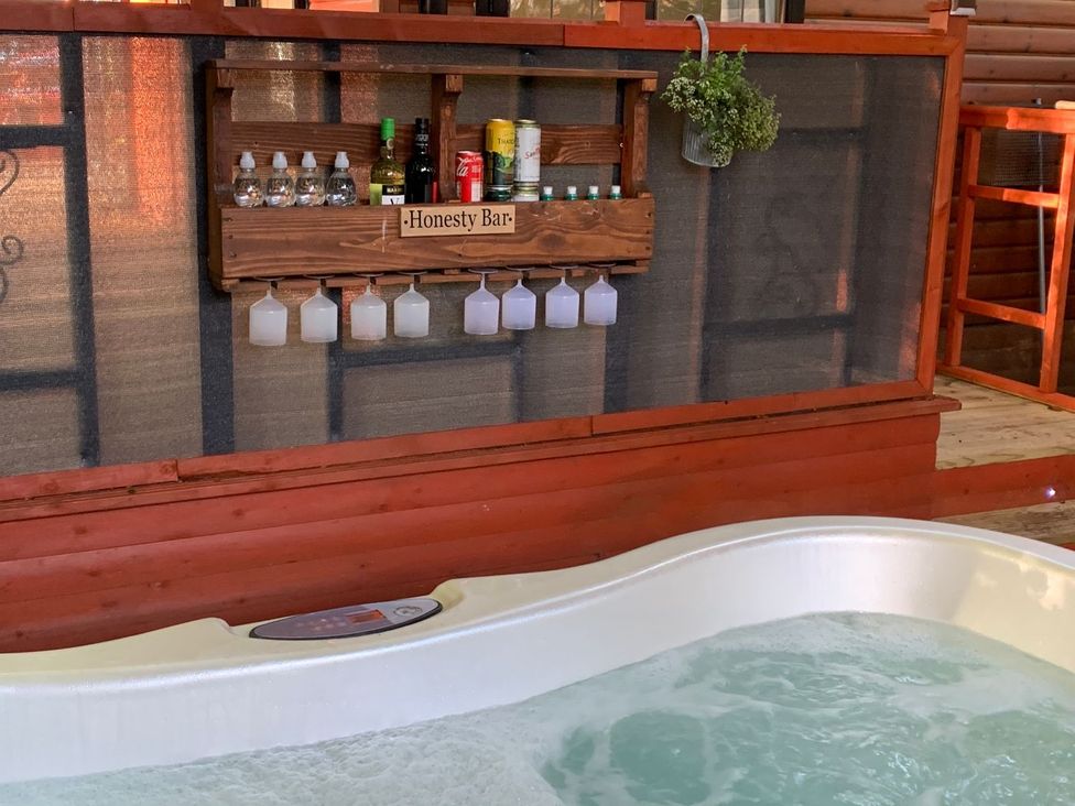 A hot tub with a wooden honesty bar at The Hermitage in Penrith