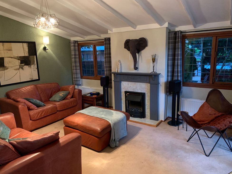 A living room with sofas and a fireplace at The Hermitage in Penrith