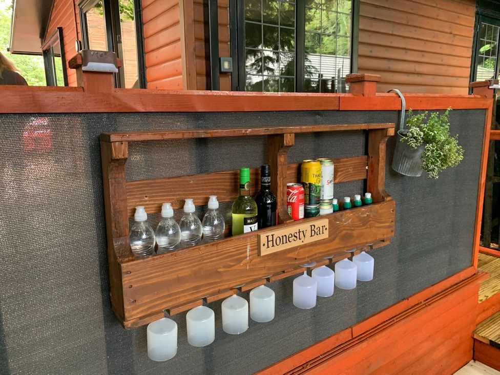 An honesty bar shelf with drinks in an outdoor area at The Hermitage in Penrith