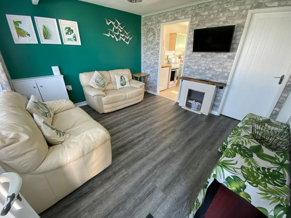 A living room with sofas and a television at Chalet 58 California, Norfolk