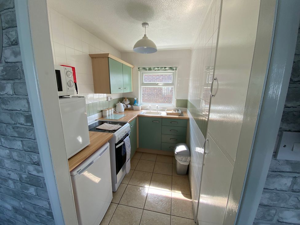 A kitchen with appliances and cabinets at Chalet 58, California, Norfolk