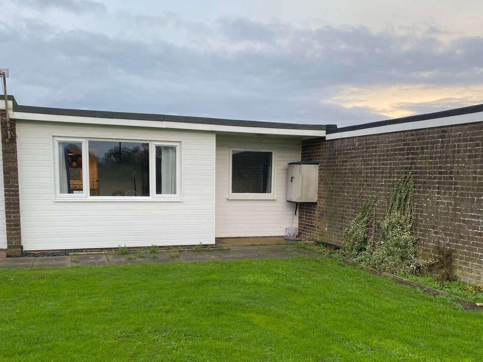 An exterior view of a house with grass at Chalet 333 in California, Norfolk