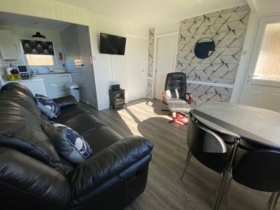 A living room with a sofa and chairs at Chalet 333 in California, Norfolk