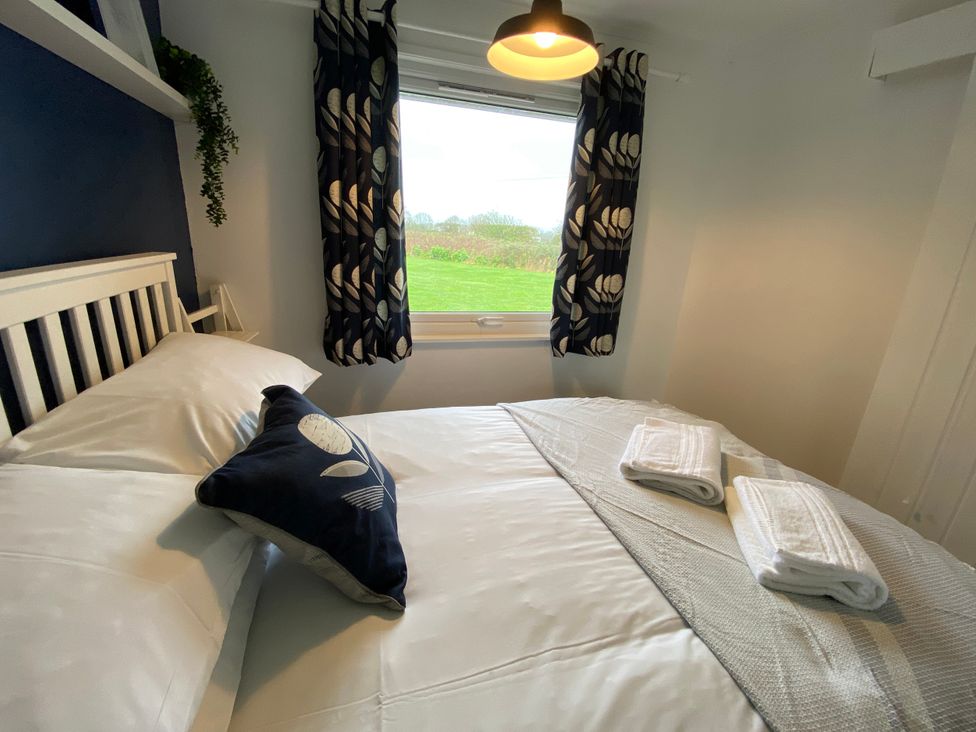 A bedroom with a bed and towels at Chalet 333, California, Norfolk