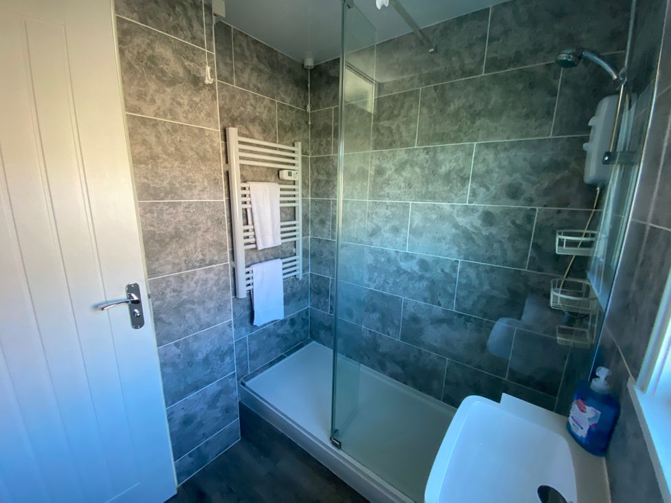 A bathroom with a shower and towel rail at Chalet 333, California, Norfolk