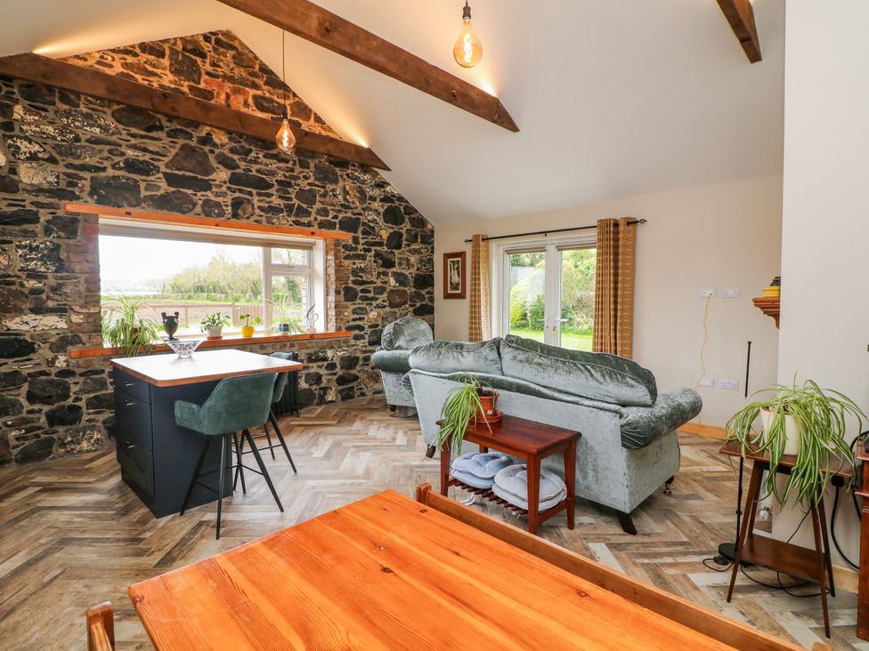 A living room with a sofa and dining table at The Stable in Dublin