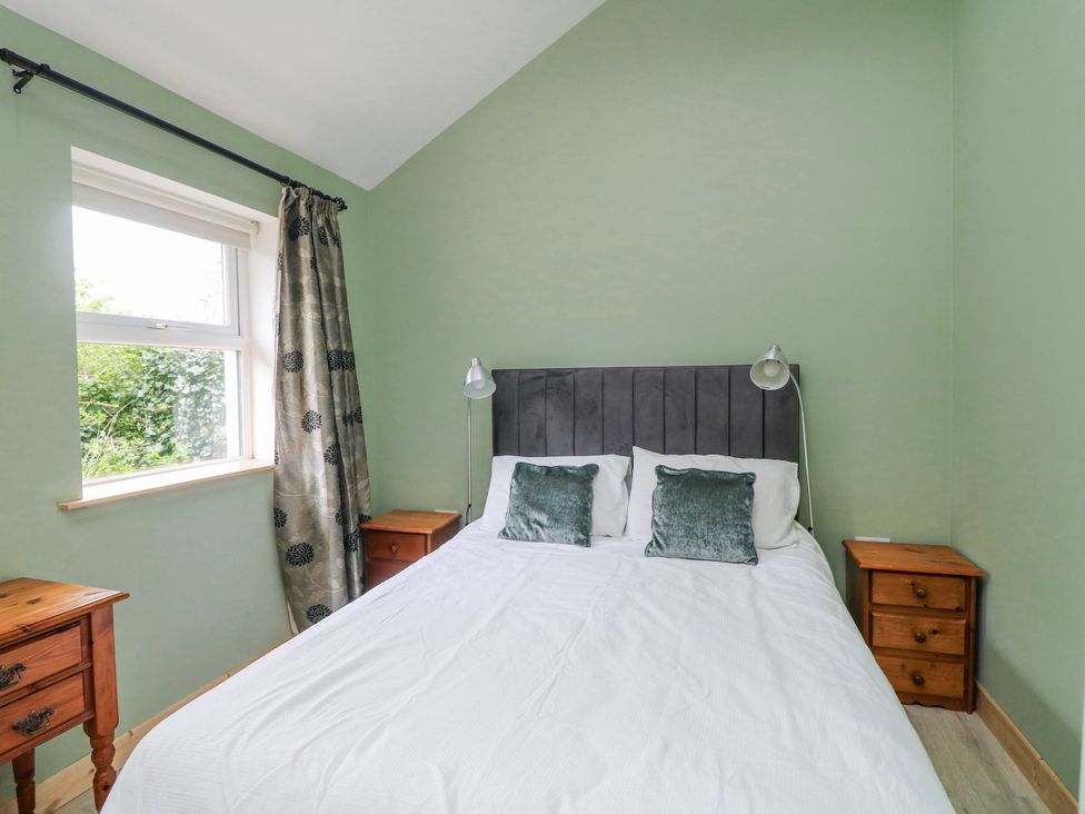 A bedroom with a bed and bedside tables at The Stable in Dublin