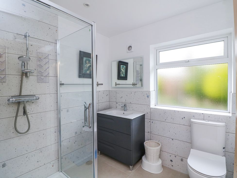 A bathroom with a shower, sink, and toilet at The Stable in Dublin