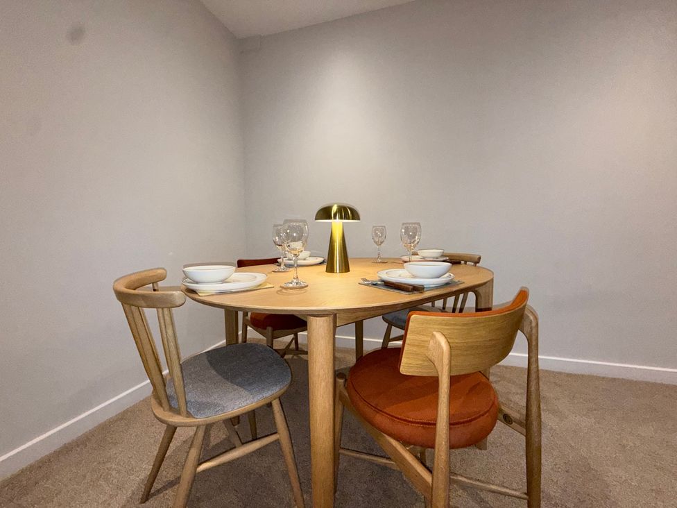 A dining room with a table set for dinner at Amber Rose in Berwick-upon-Tweed
