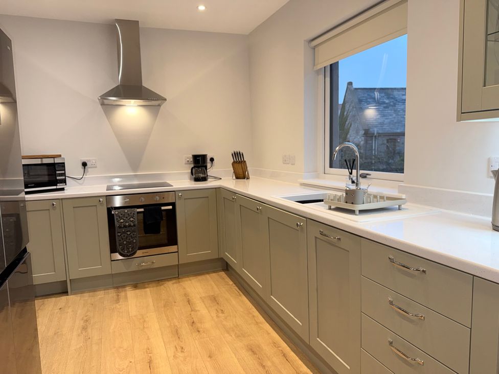 A kitchen with cabinets and appliances at Amber Rose in Berwick-upon-Tweed