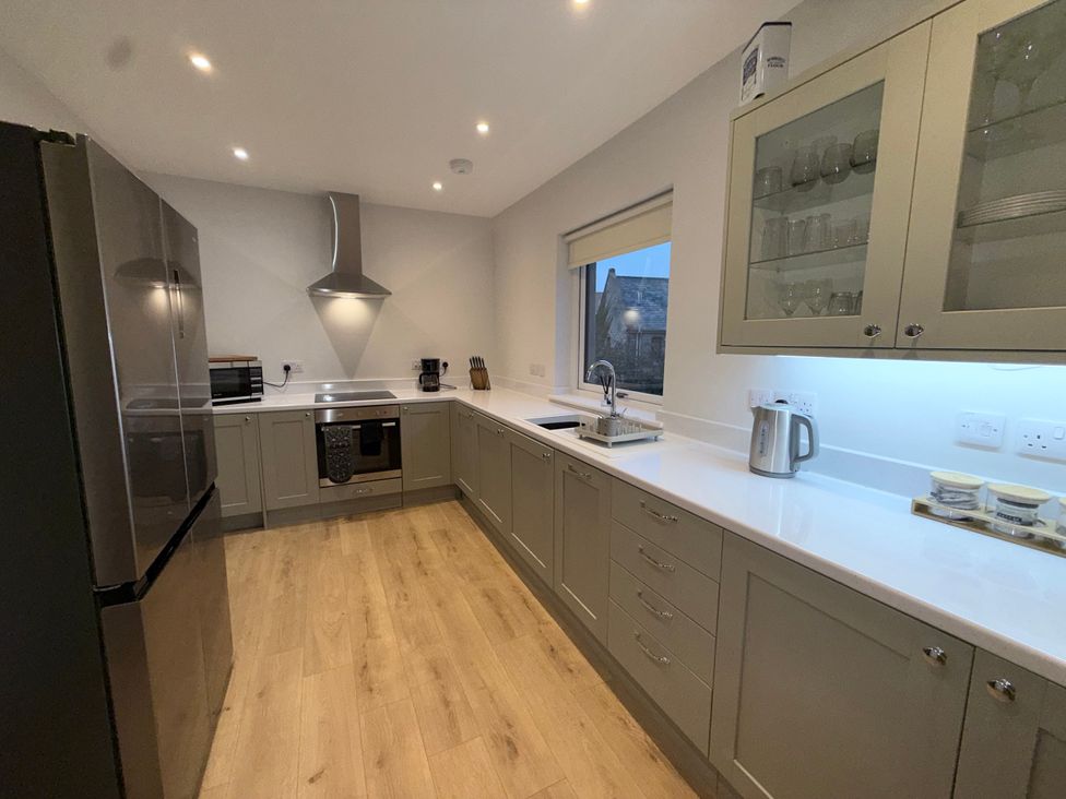 A kitchen with appliances and cabinets at Amber Rose in Berwick-upon-Tweed