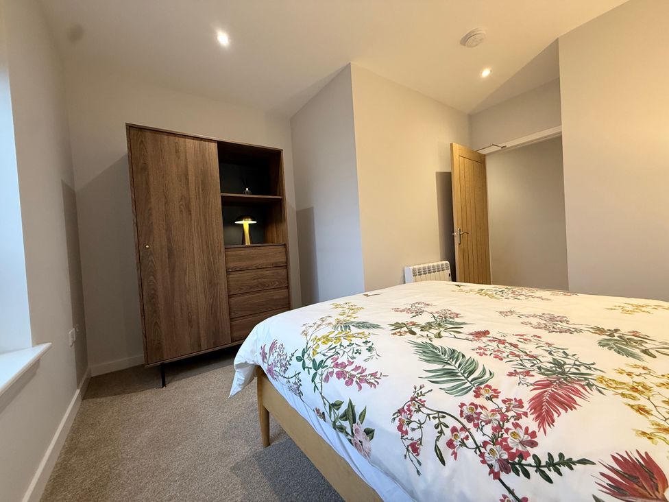 A bedroom with a bed and wardrobe at Amber Rose in Berwick-upon-Tweed