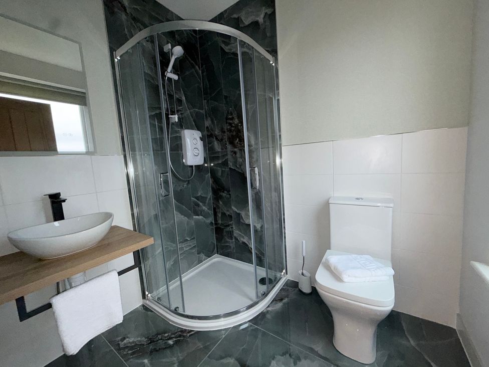 A bathroom with a shower and toilet at Amber Rose in Berwick-upon-Tweed