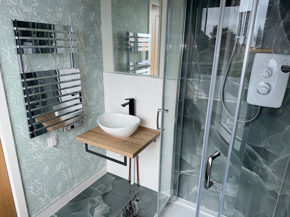 A bathroom with a sink and shower unit at Amber Rose in Berwick-upon-Tweed