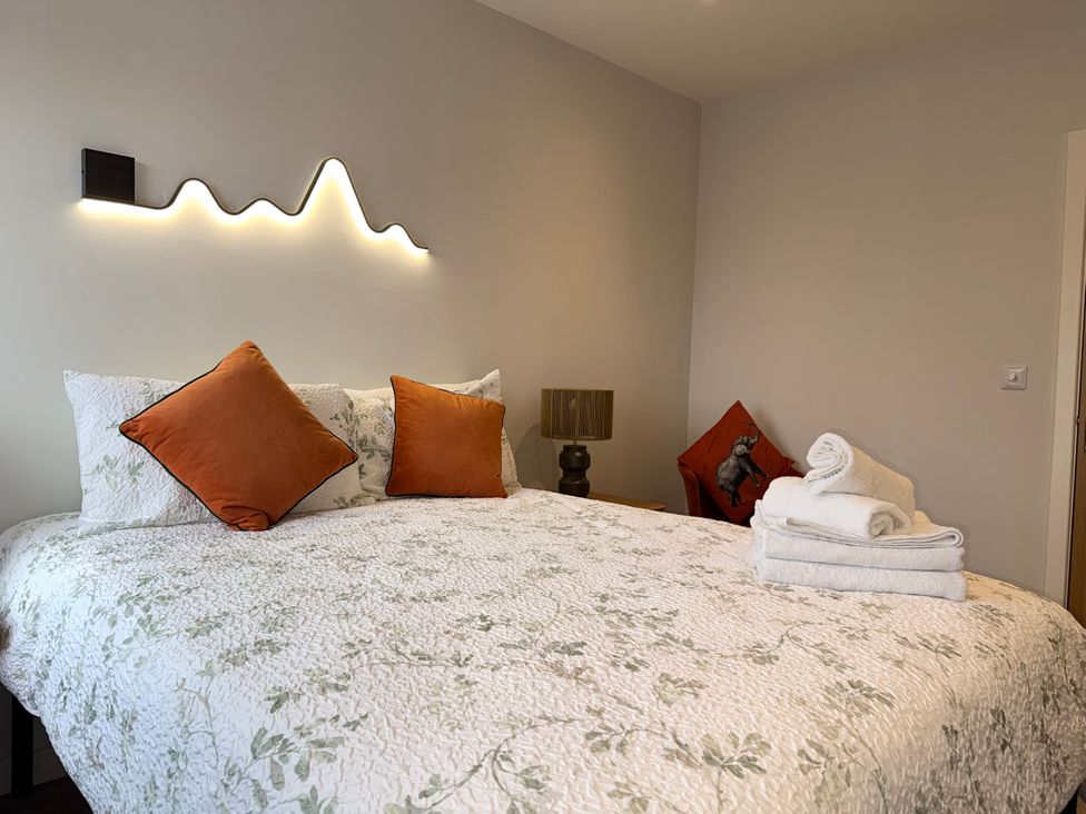 A bedroom with a bed and pillows at Amber Rose in Berwick-upon-Tweed