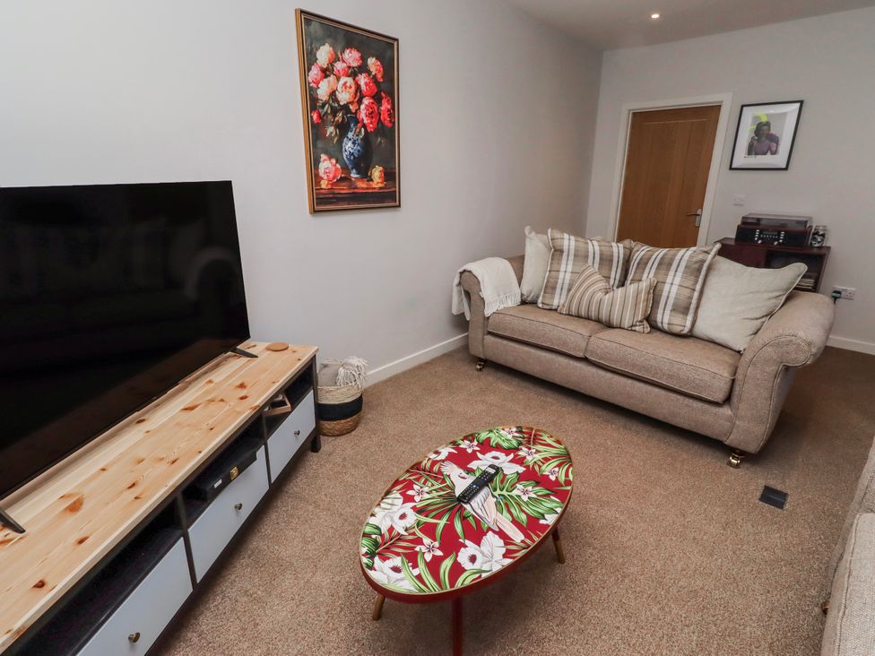 A living room with a sofa and a coffee table at Amber Rose in Berwick-Upon-Tweed