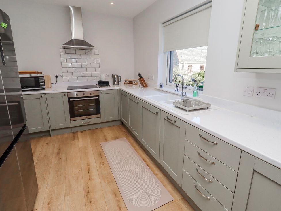 A kitchen with cabinets and appliances at Amber Rose in Berwick-Upon-Tweed
