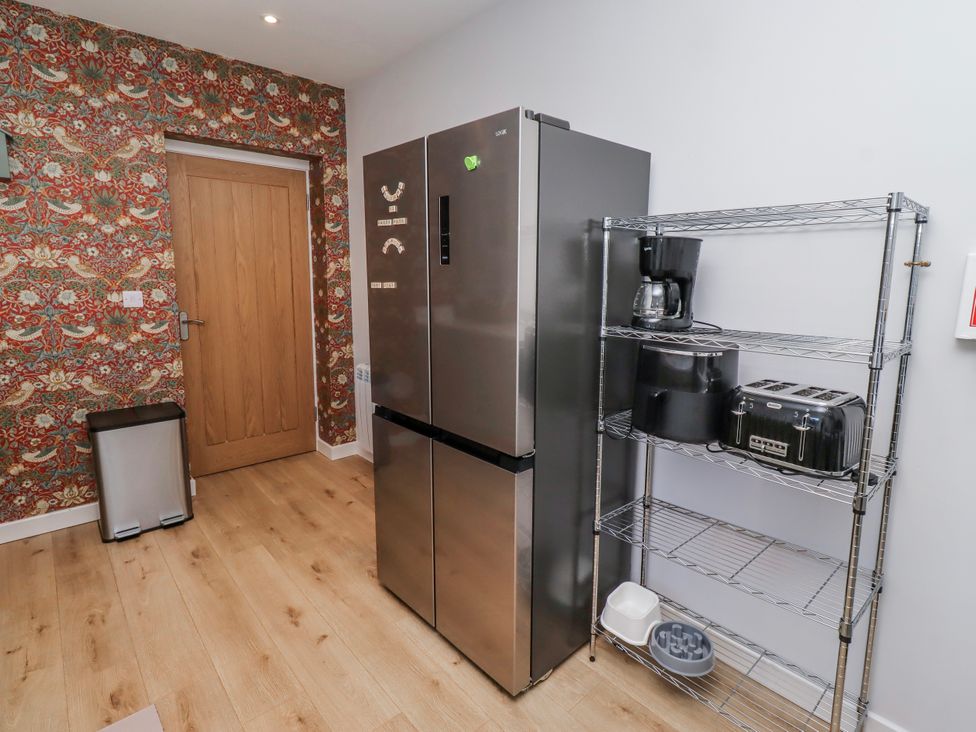 A kitchen with a refrigerator and various small appliances at Amber Rose in Berwick-Upon-Tweed