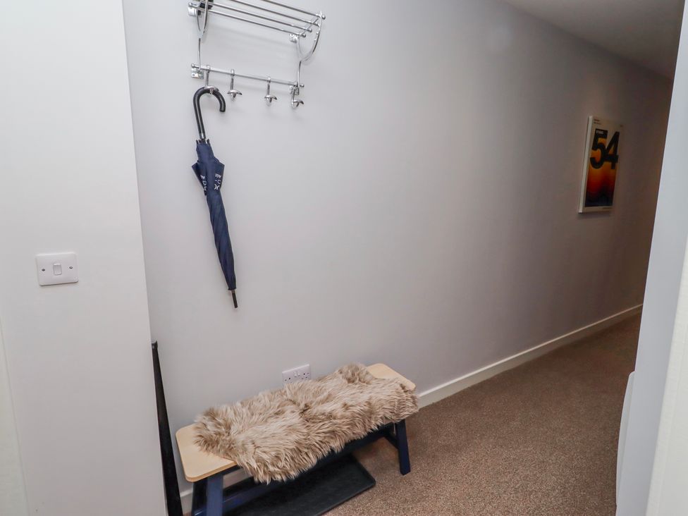 A hallway with coat hooks and a bench at Amber Rose in Berwick-Upon-Tweed