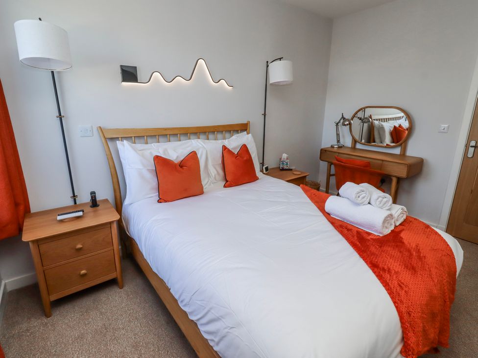 A bedroom with a bed and vanity table at Amber Rose in Berwick-Upon-Tweed