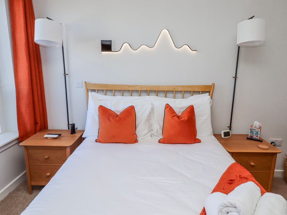 A bedroom with a bed and bedside tables at Amber Rose in Berwick-Upon-Tweed