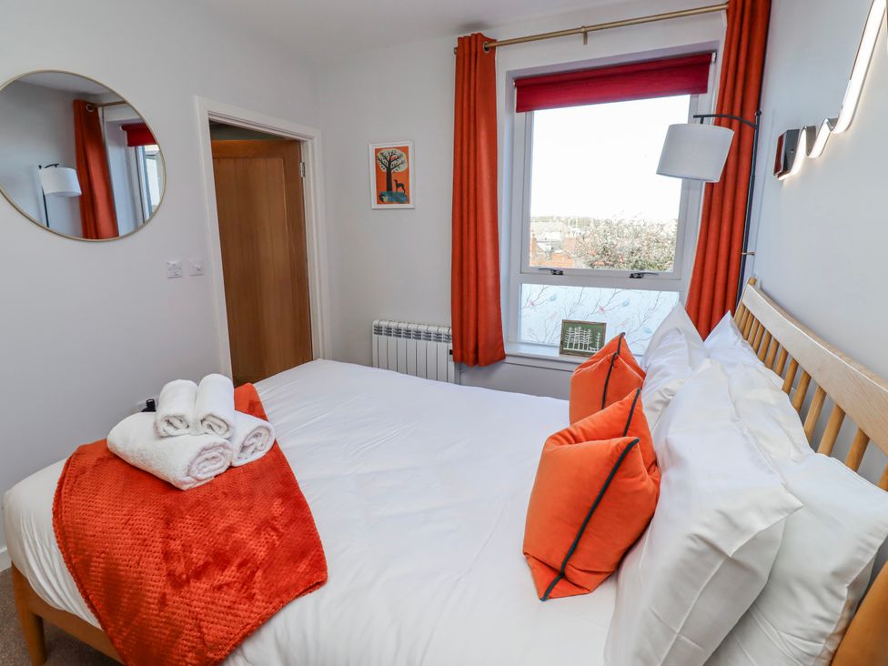 A bedroom with a bed and towels at Amber Rose in Berwick-Upon-Tweed