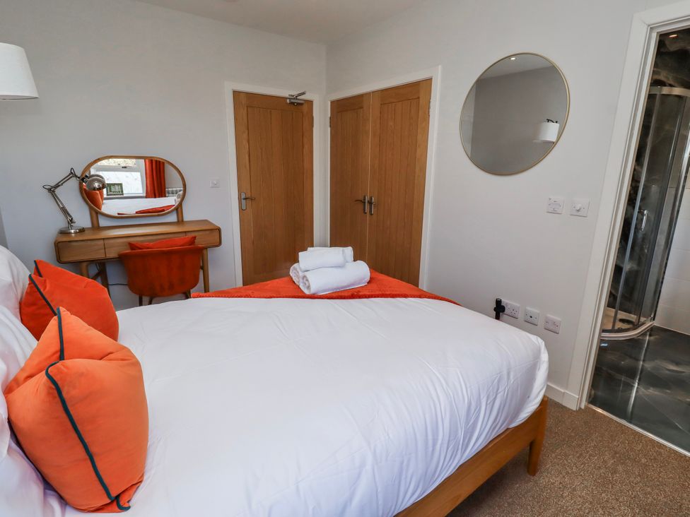A bedroom with a bed and a desk at Amber Rose in Berwick-Upon-Tweed