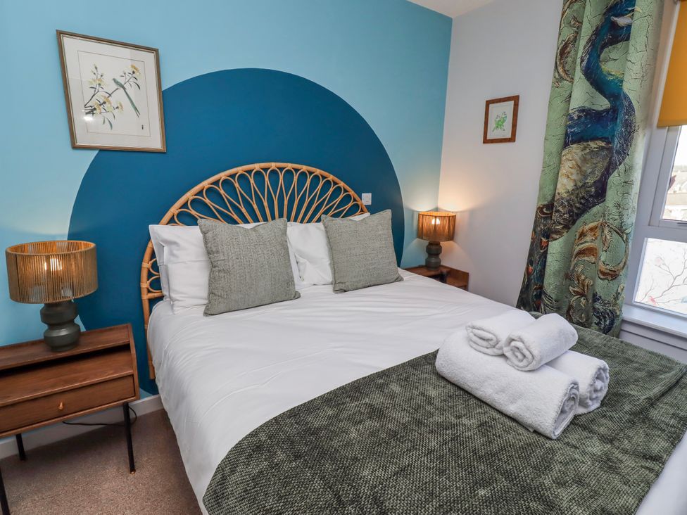 A bedroom with a bed and decorative elements at Amber Rose in Berwick-Upon-Tweed