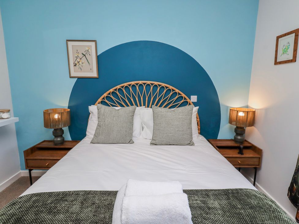 A bedroom featuring a bed with pillows and bedside lamps at Amber Rose Berwick-Upon-Tweed