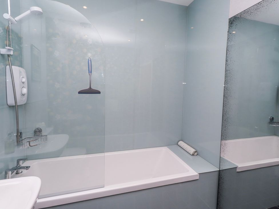 A bathroom with a bathtub and shower system at Amber Rose in Berwick-Upon-Tweed
